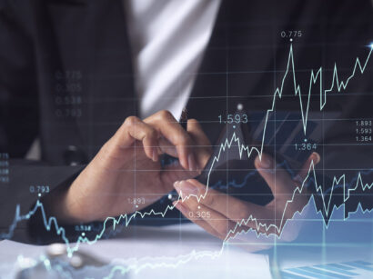 A woman financial trader in formal wear is checking the phone to sign the contract to invest money in stock market. Internet trading and wealth management concept. Forex hologram chart.