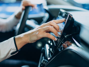 Woman touching screen in her car